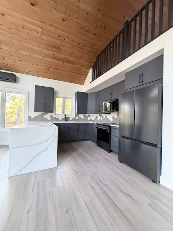 Modern kitchen with vinyl flooring by Flooring and More Superstore